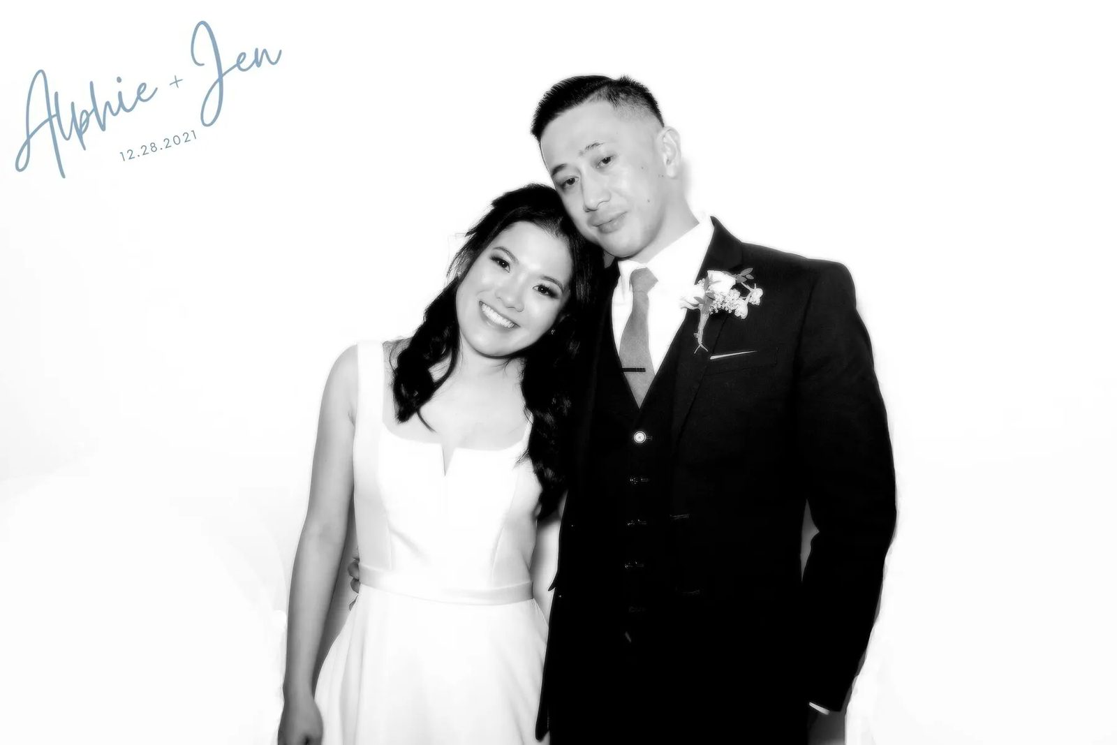Newlyweds in a black-and-white glam booth photo
