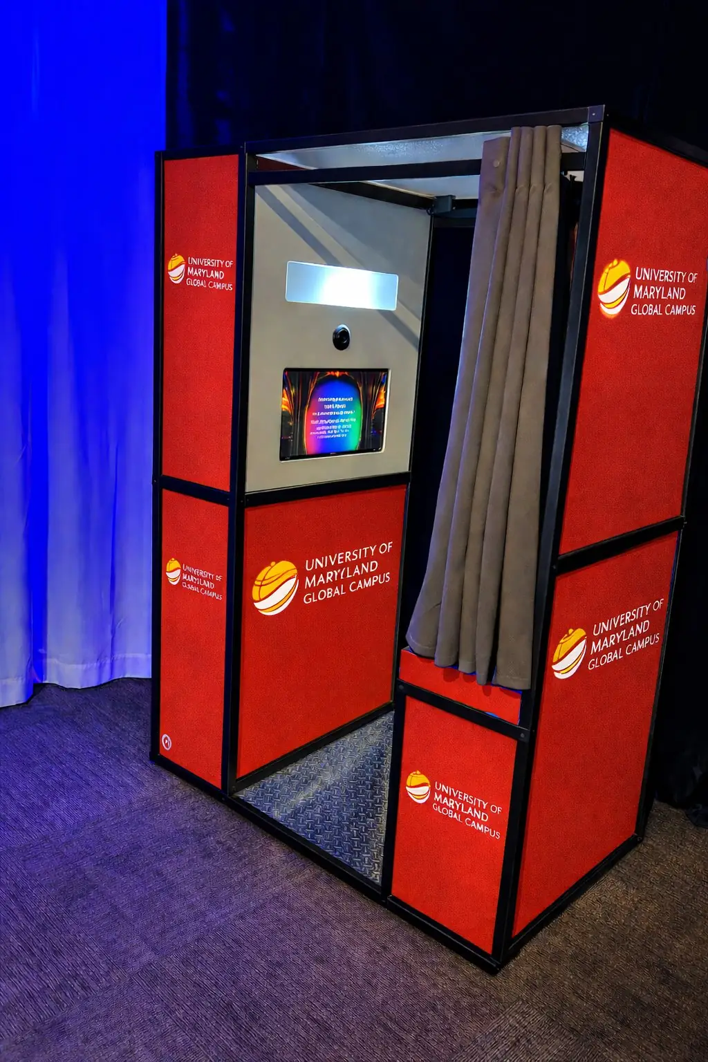 MojoHaus enclosed photo booth wrapped in University of Maryland Global Campus branding