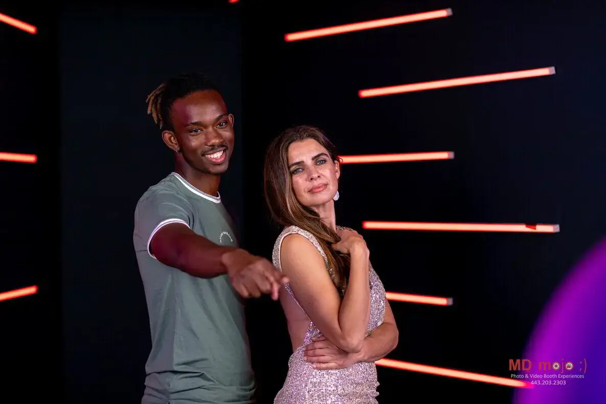 Guests posing in the Vogue photo booth with LED backdrop