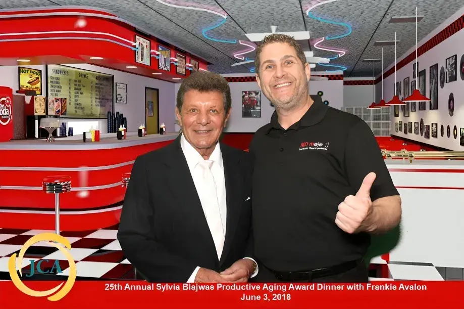 A green screen photo booth print handed to guests at a Maryland reception