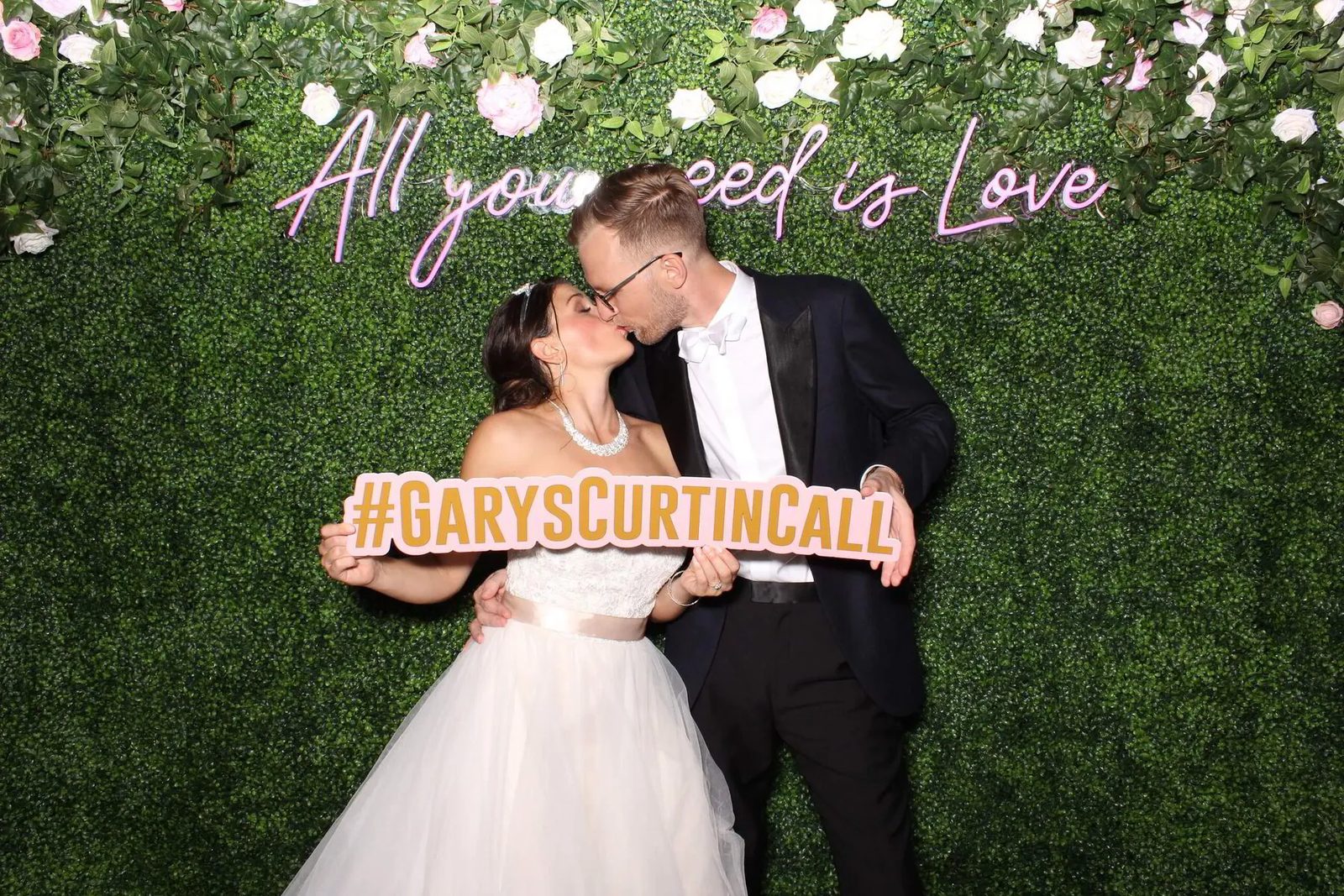 Couple enjoying a wedding photo booth