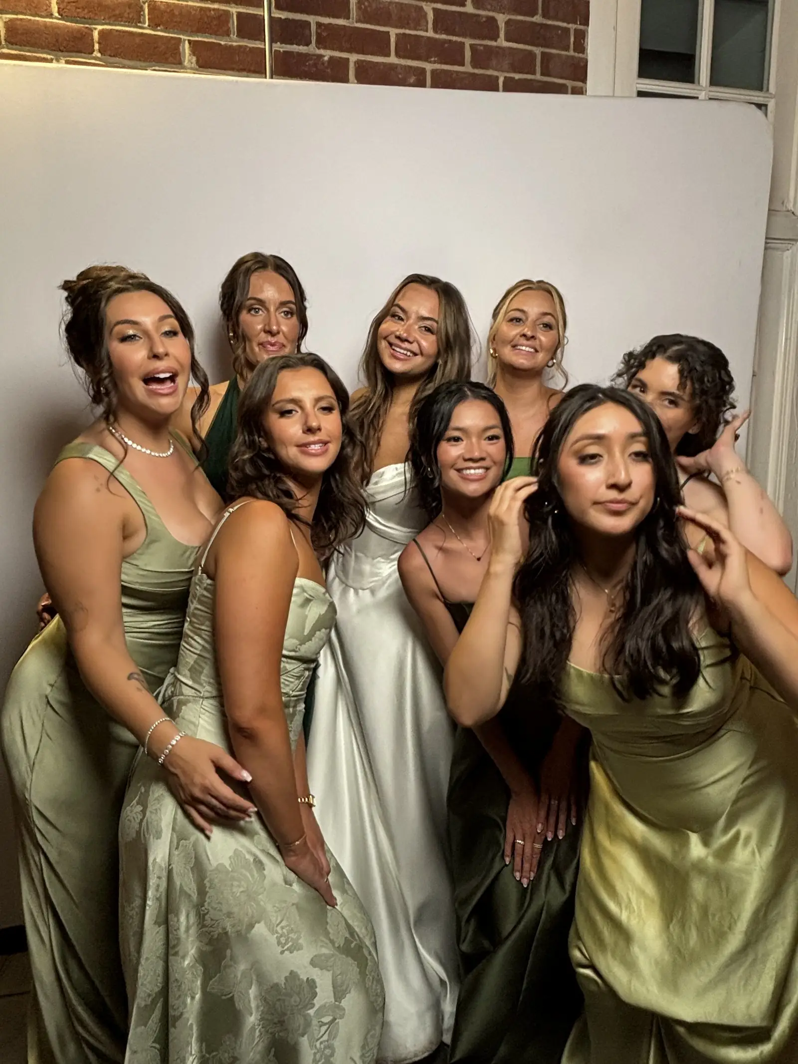 A bridal party photographed against a clean white backdrop at the Ikonic vintage photo booth