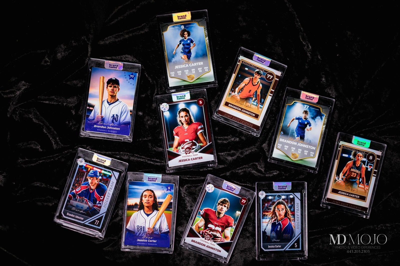 Eleven finished MD Mojo trading cards in protective slabs laid out on black velvet, across five different sports designs